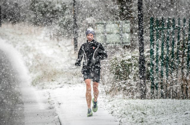 <p>Jogger runs through snow in Knaresborough, in North Yorkshire, earlier this year </p>